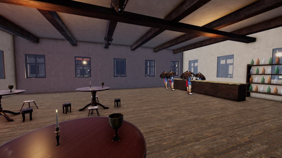 The Halo and Hearth inn: tables, stools and the bottle wall behind the bar